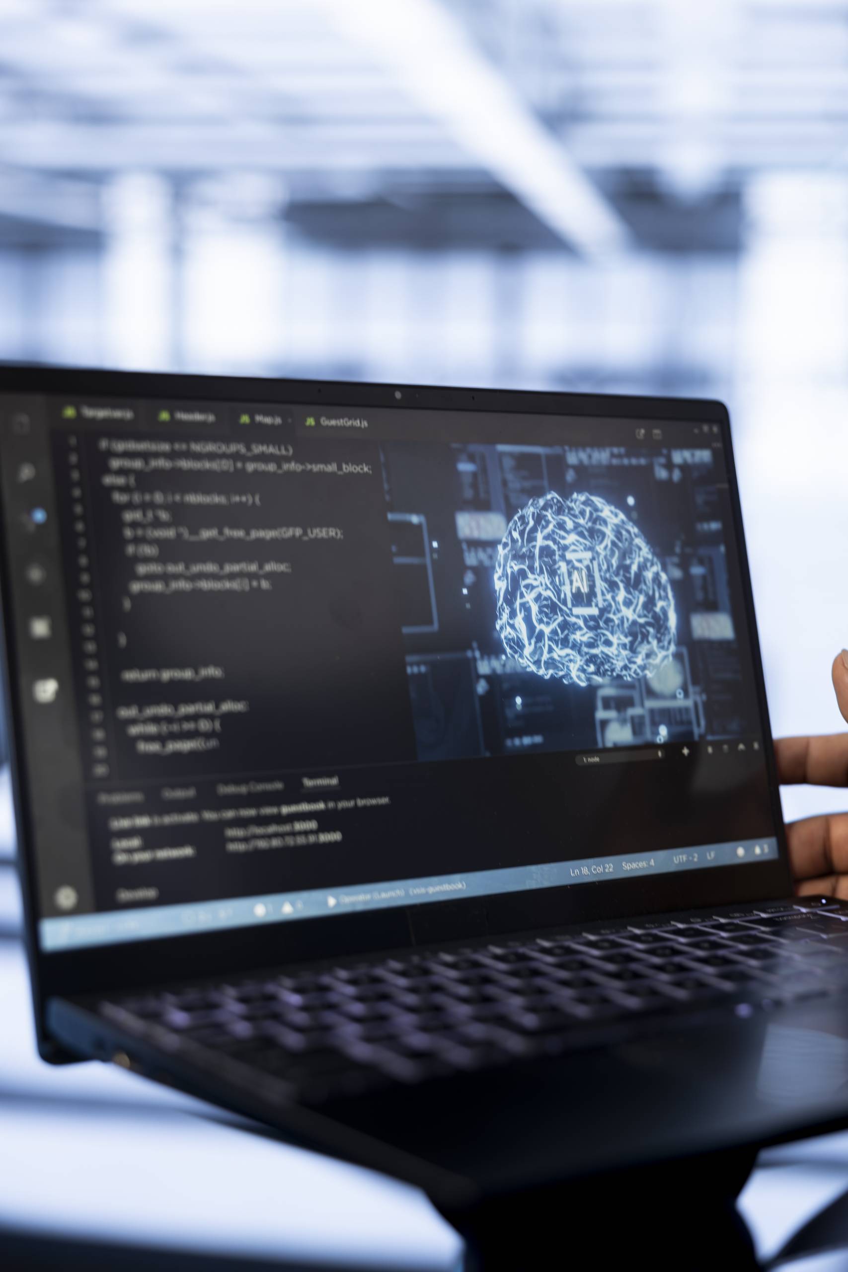 Computer scientist using laptop in data center, updating AI systems. Close up shot of device used by server room worker upgrading artificial intelligence simulation model